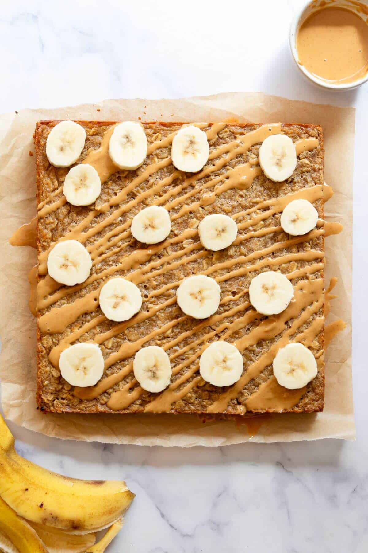 Cooled peanut butter banana baked oatmeal topped with fresh banana slices, ready to serve.