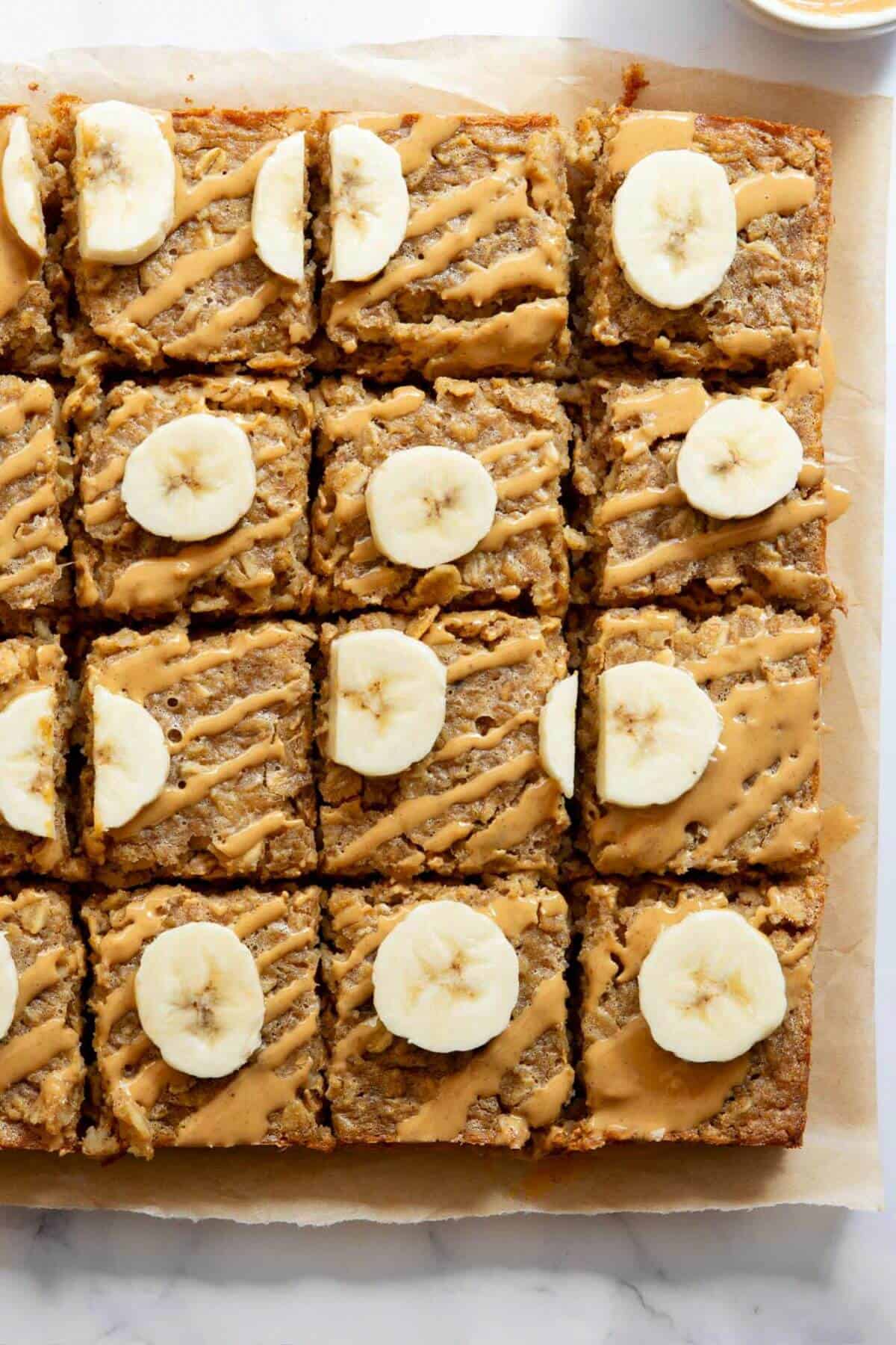 Healthy, gluten-free peanut butter banana baked oatmeal cut into squares for easy serving.