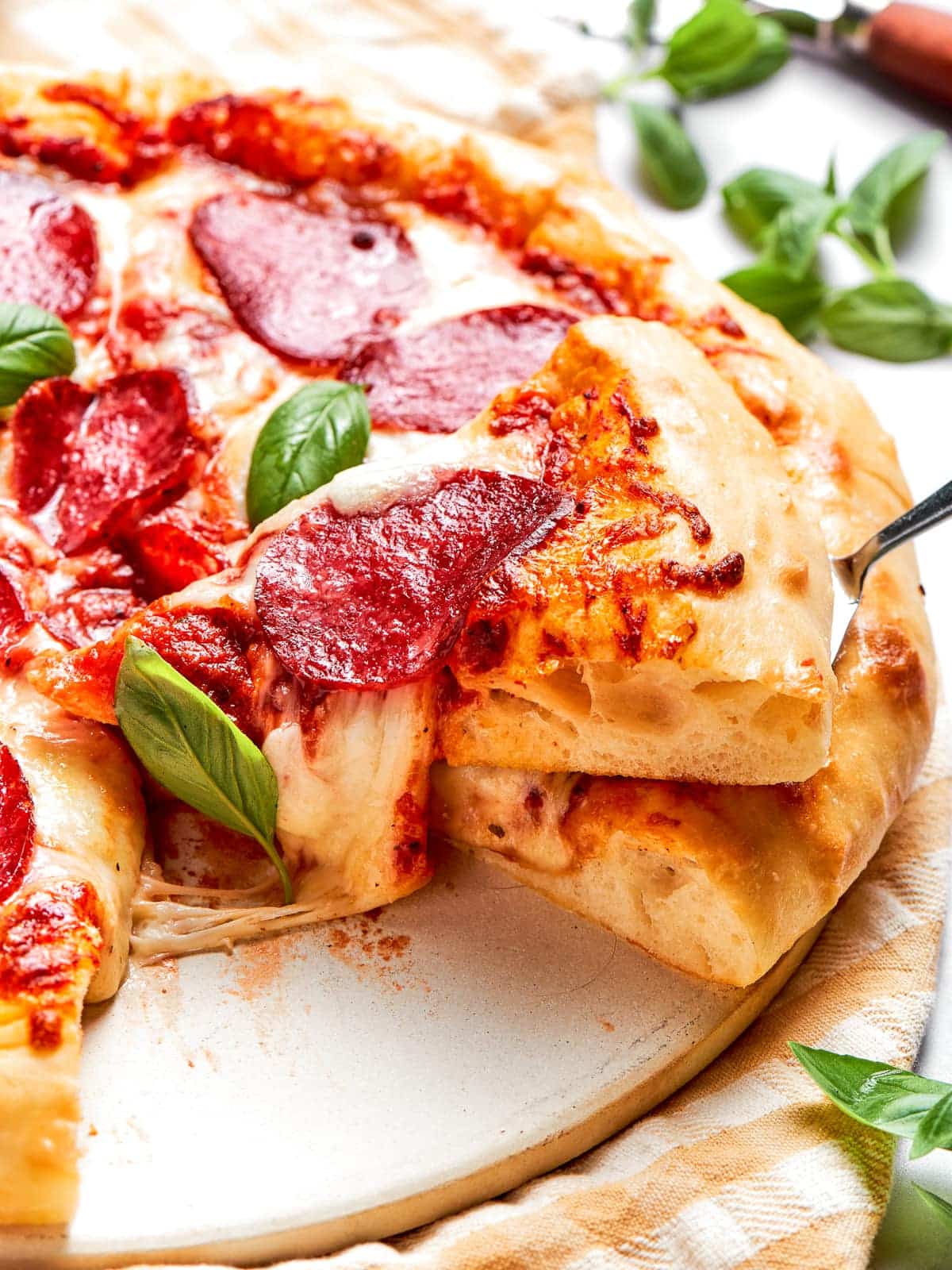 Cheese stretching between two pizza slices mid-pull.