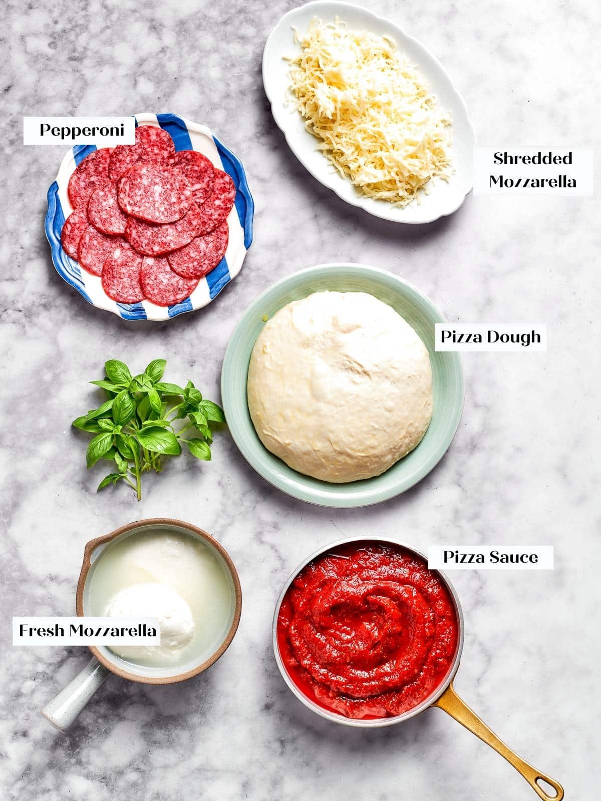 All pepperoni pizza ingredients displayed on the kitchen counter.