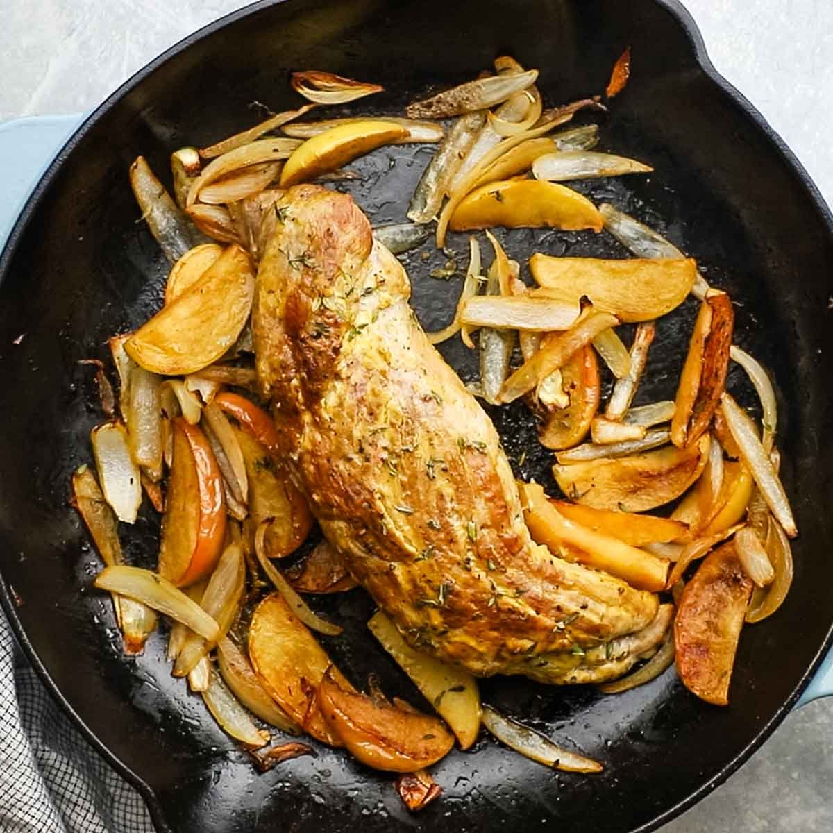 pork roasted in the pan with apples and onions