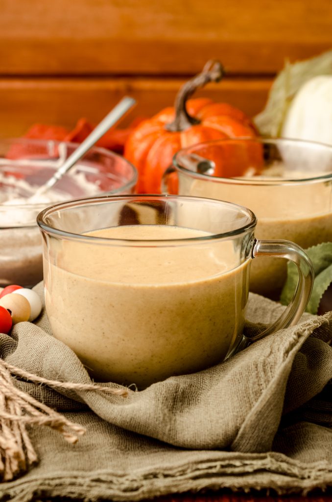 Pumpkin spice hot chocolate in a glass mug.