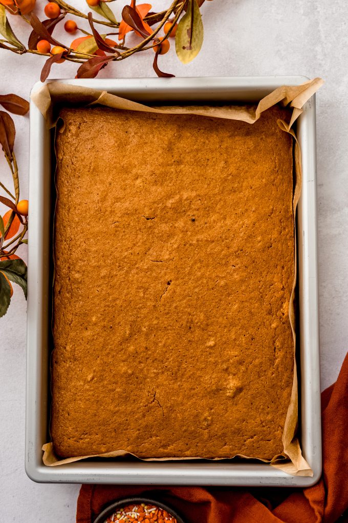 Aerial photo of pumpkin sheet cake sitting in a baking pan.