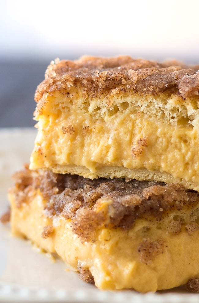 Slice of pumpkin cheesecake bar dessert served as a fall treat with coffee