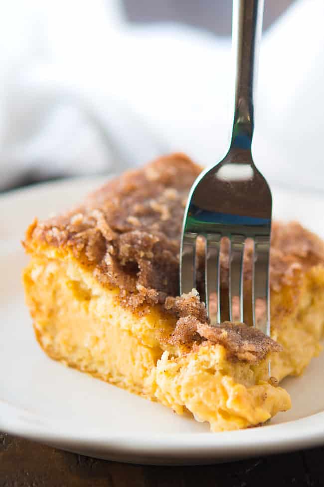 Flaky crescent dough pumpkin cheesecake dessert bars cooling on a plate