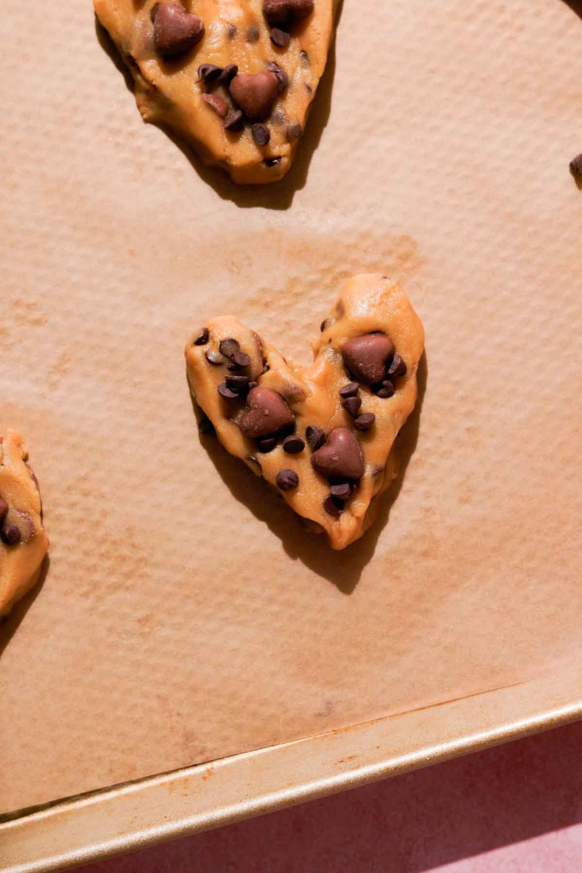 shaped cookie dough hearts with chocolate chips on top