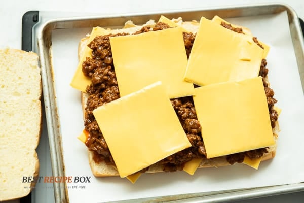 Extra cheese added on top of sloppy joe mix