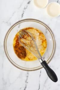 A bowl of eggs and heavy cream with vanilla and cinnamon added.