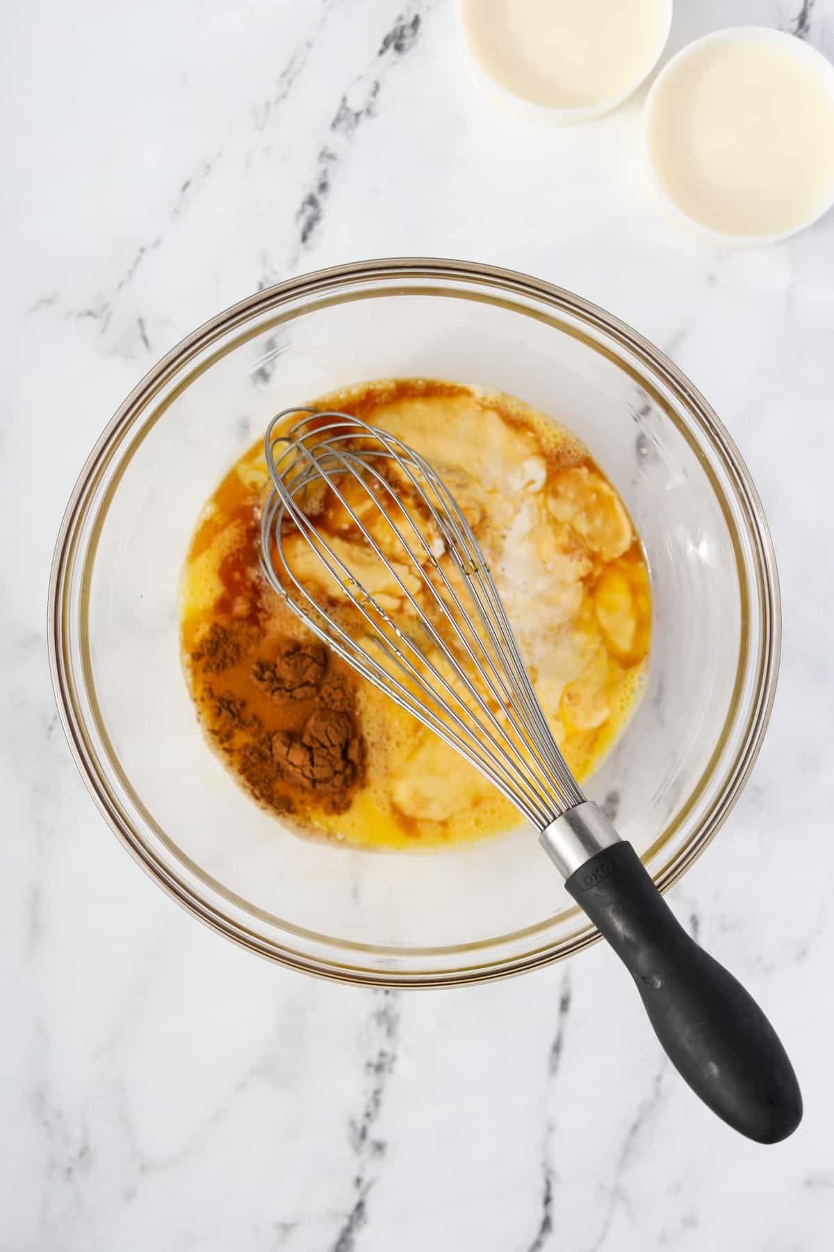 A bowl of eggs and heavy cream with vanilla and cinnamon added.