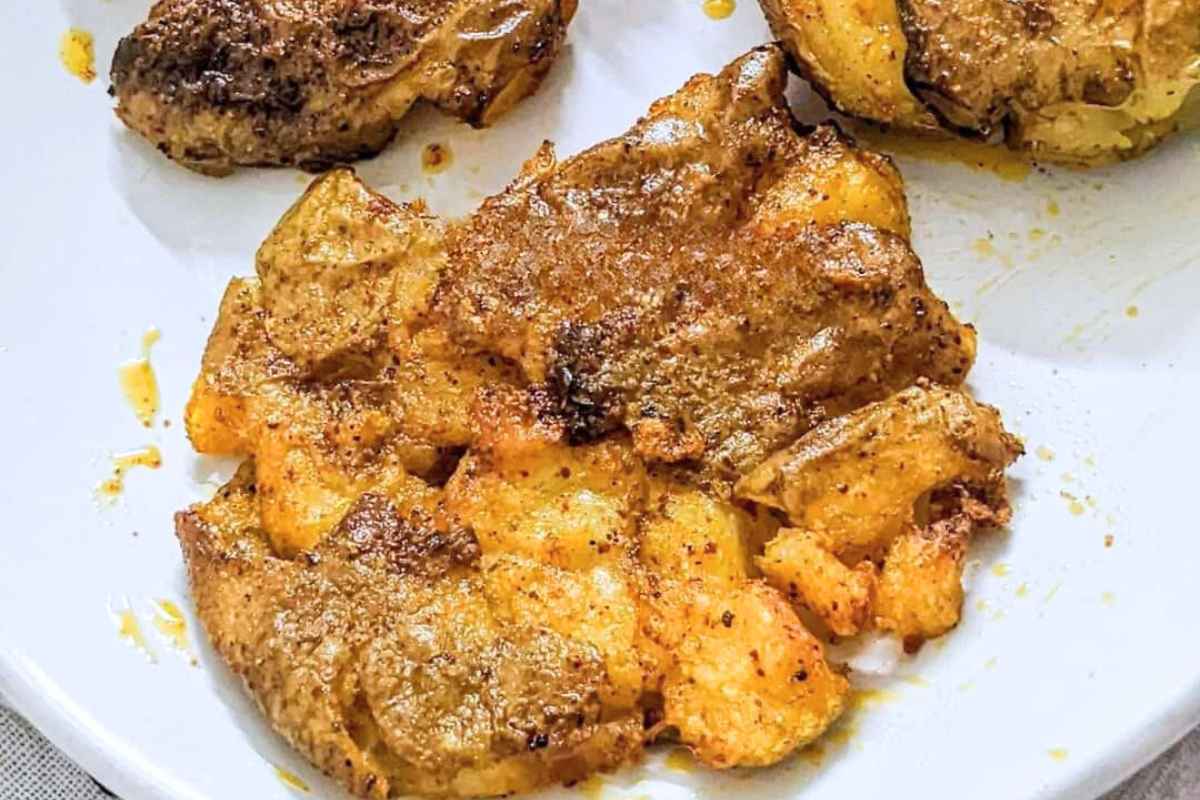 Smashed potatoes on a white plate