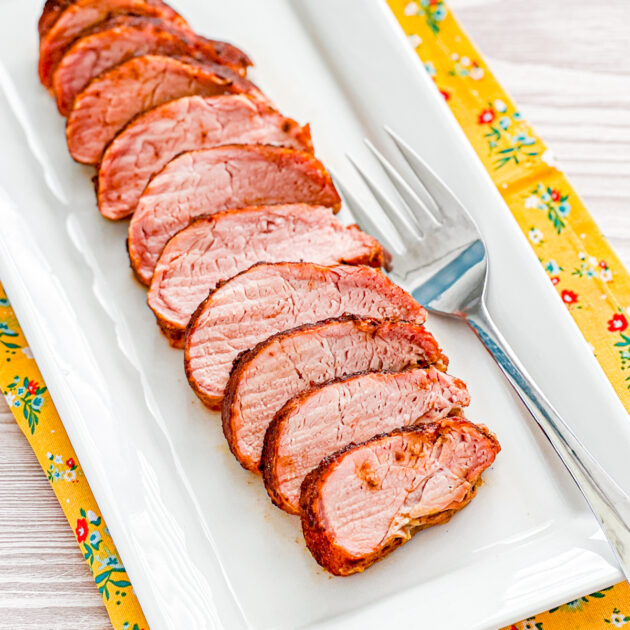 smoked pork tenderloin on a wwhite platter