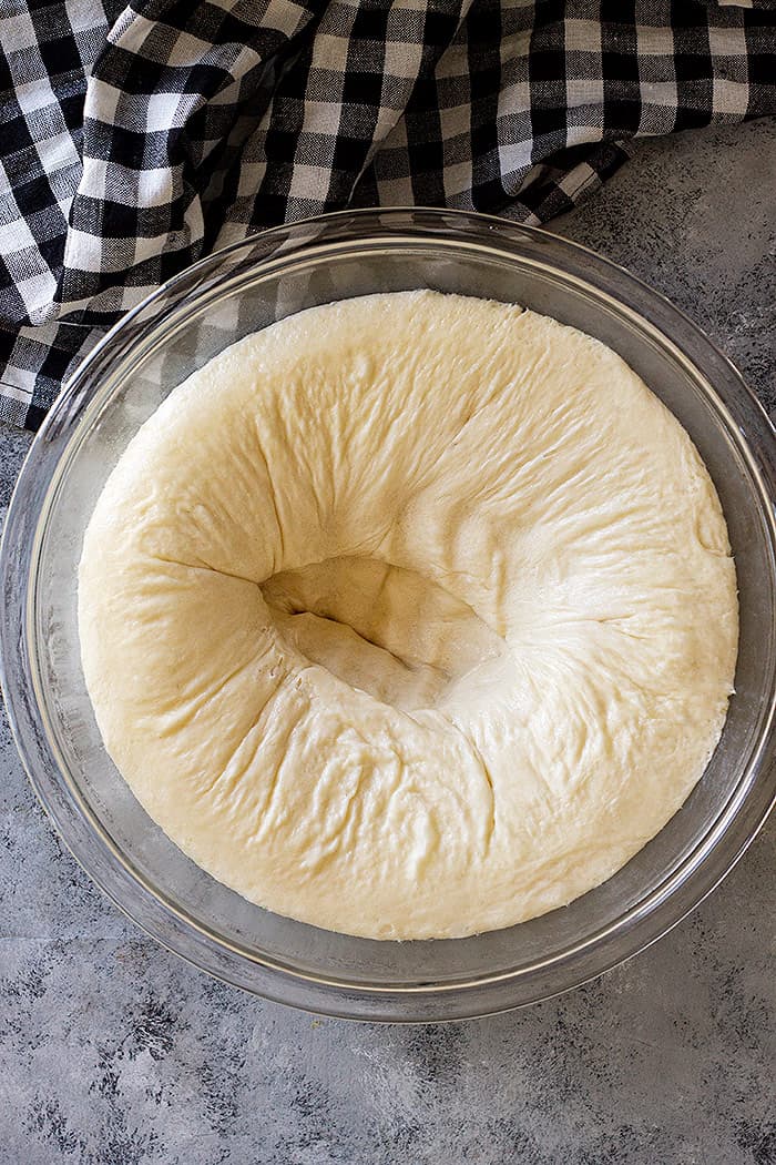 Punching the dough down after the first rise.