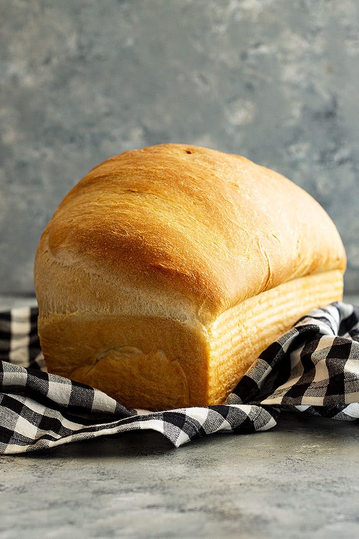 A tall loaf of white bread fresh from the oven.