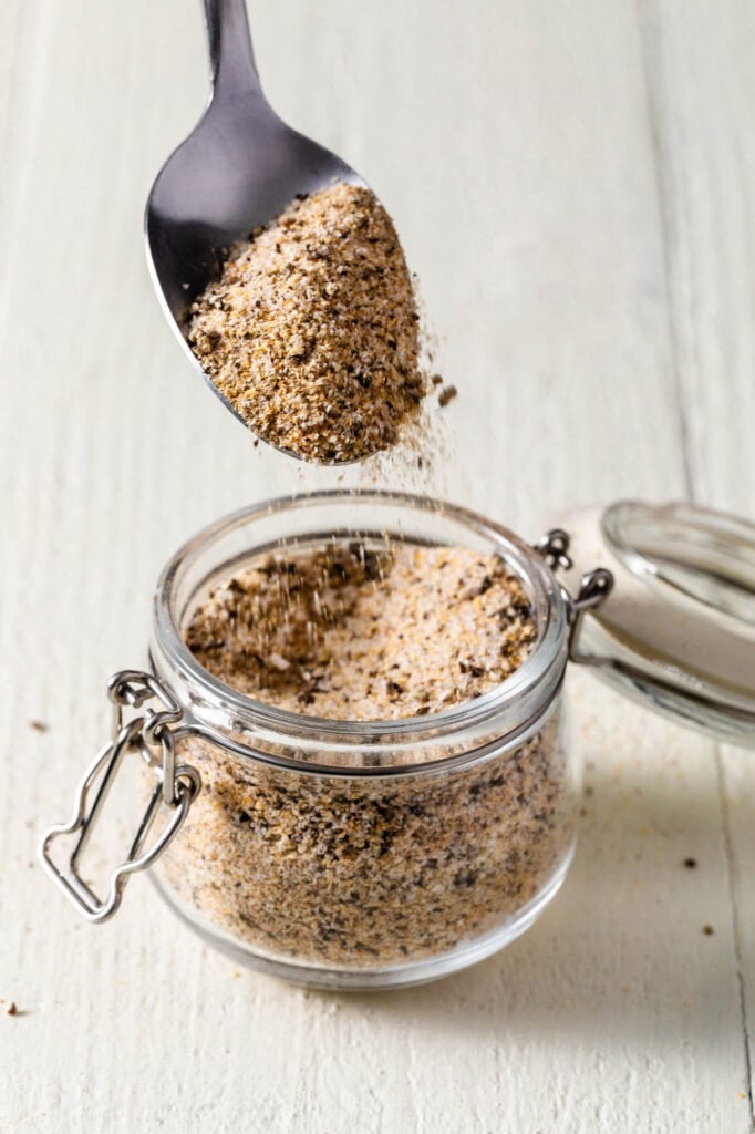 scooping soul food seasoning with a spoon 