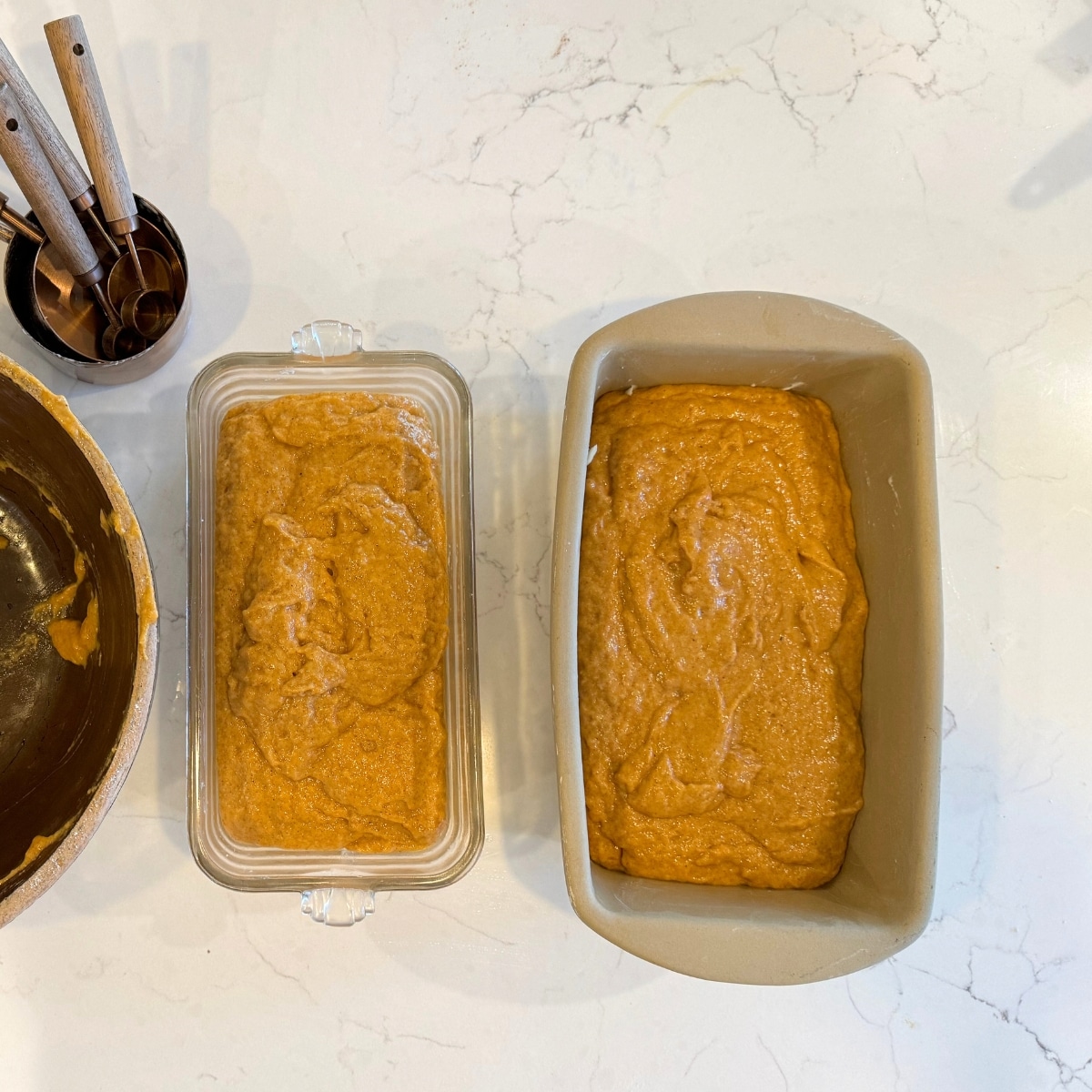 sourdough pumpkin bread dough in buttered loaf pans