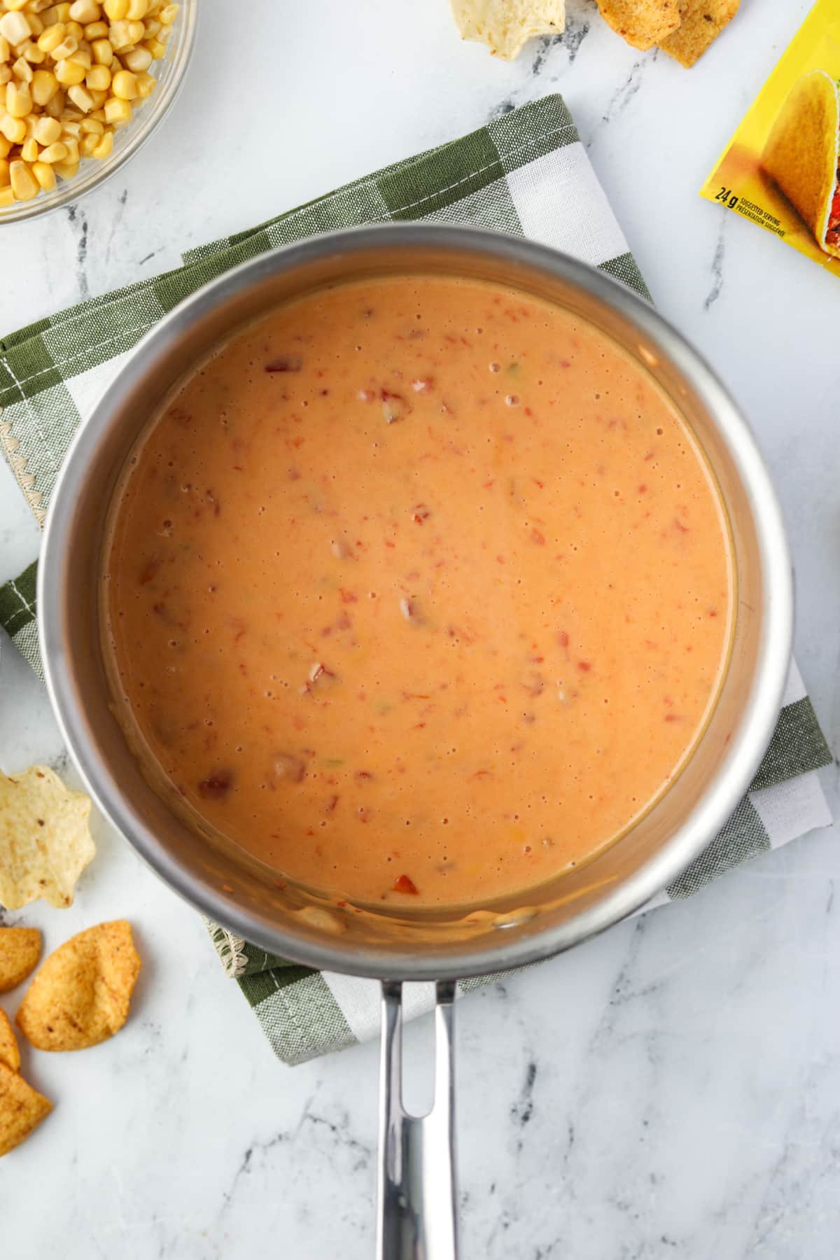 A saucepan with Rotel dip melted inside.
