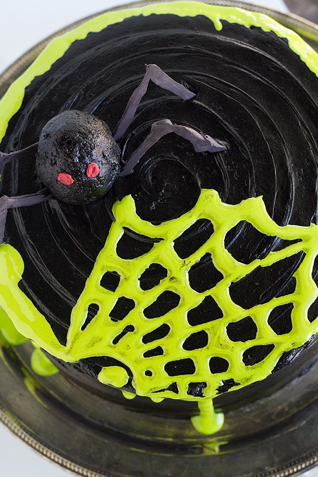 Spooky Spiderweb Cake - the perfect chocolate Halloween cake with black chocolate frosting and toxic green fluff sludge. It should be at all the parties!