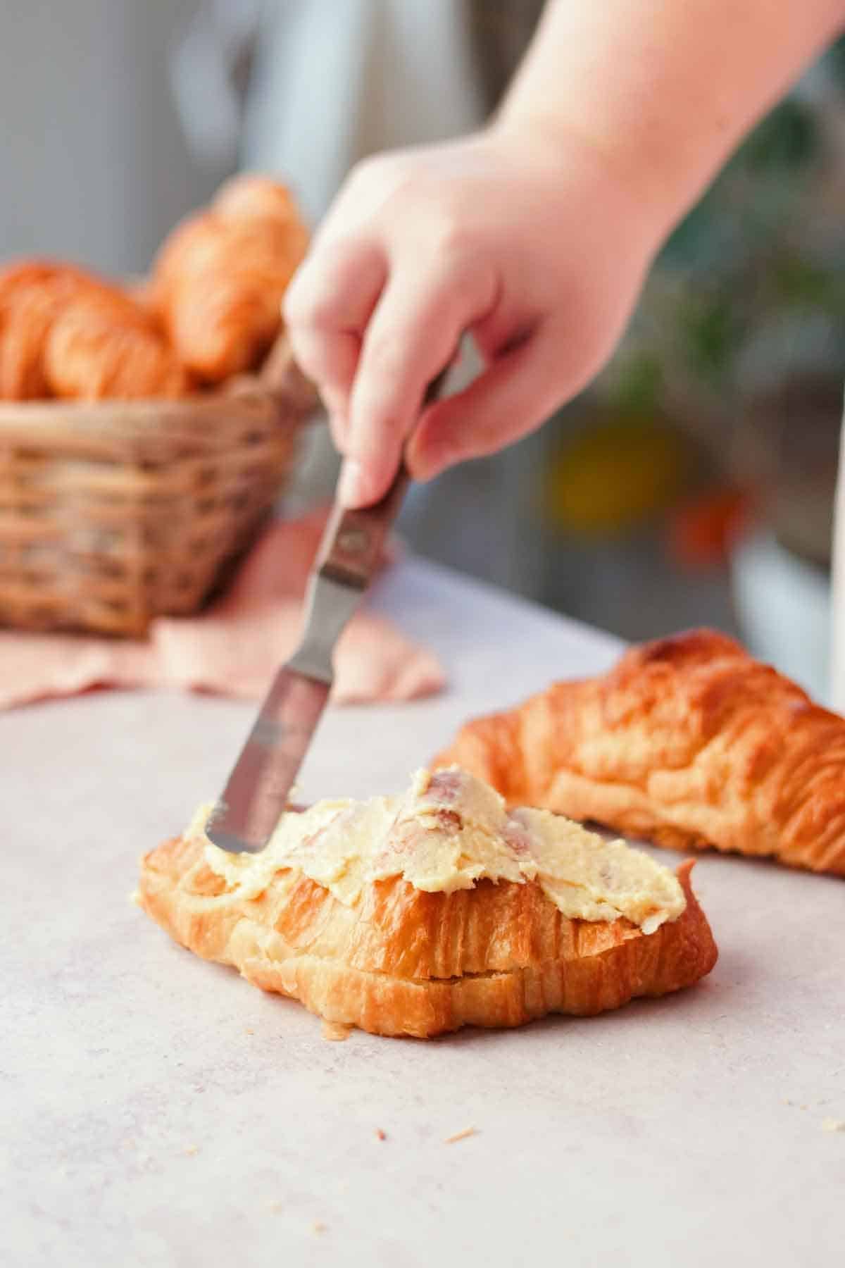 spreading filling on top of croissants