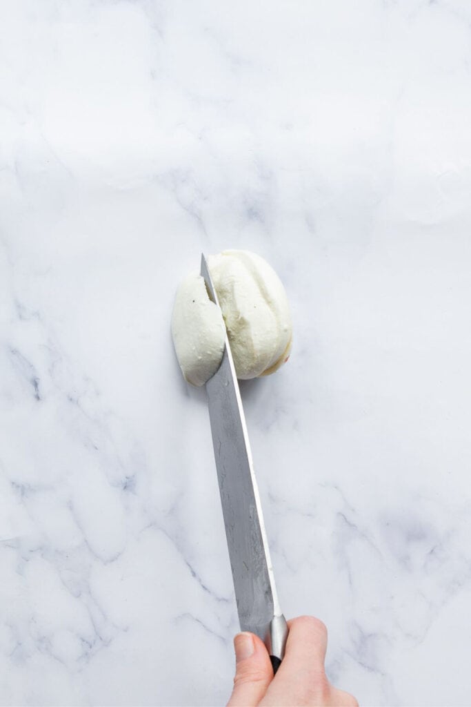 cutting fresh mozzarella into slices