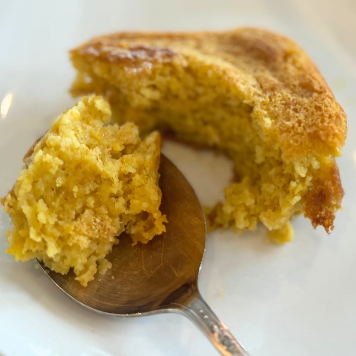 sweet and moist sourdough corn spoon bread on spoon