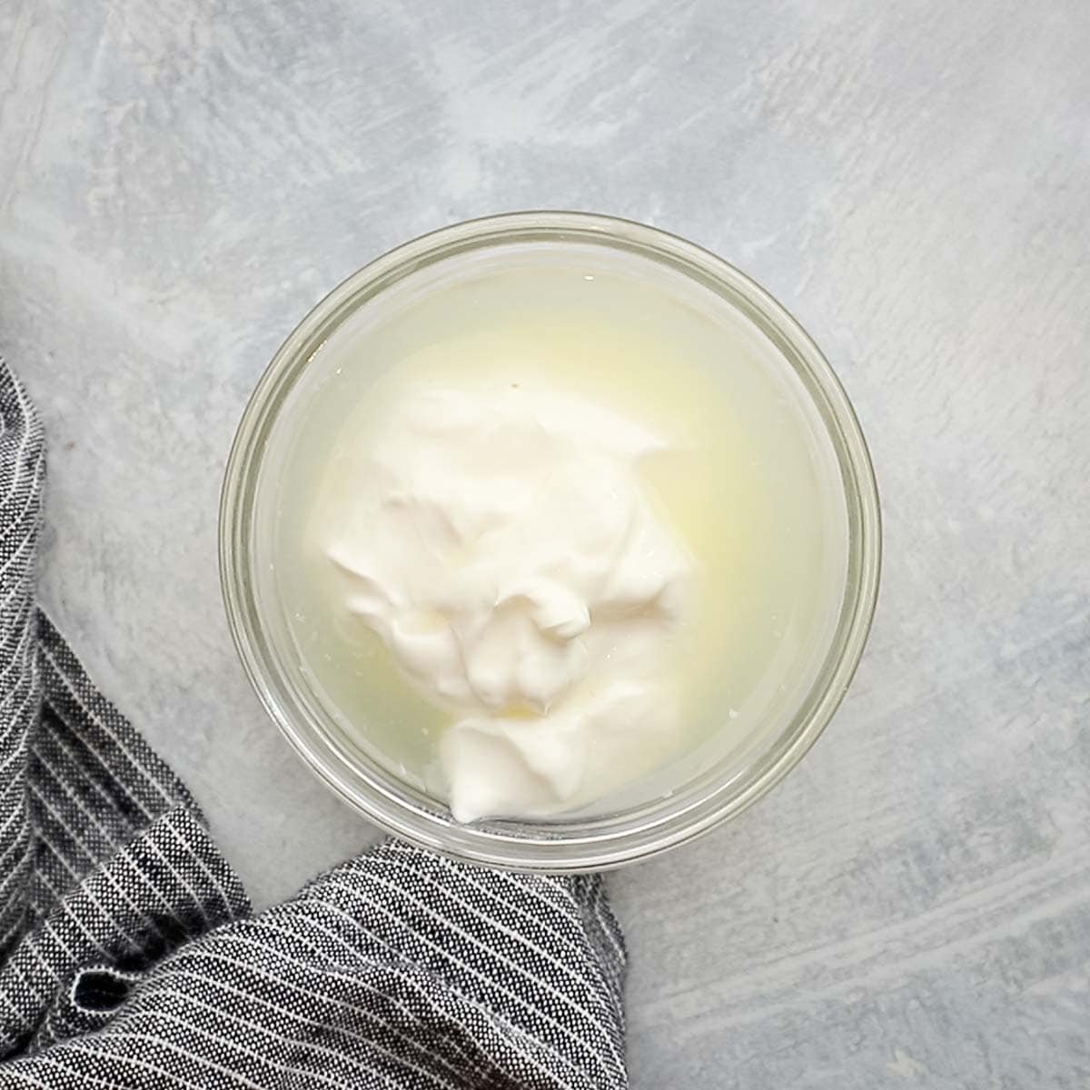 lime juice and water added to sour cream in a small bowl