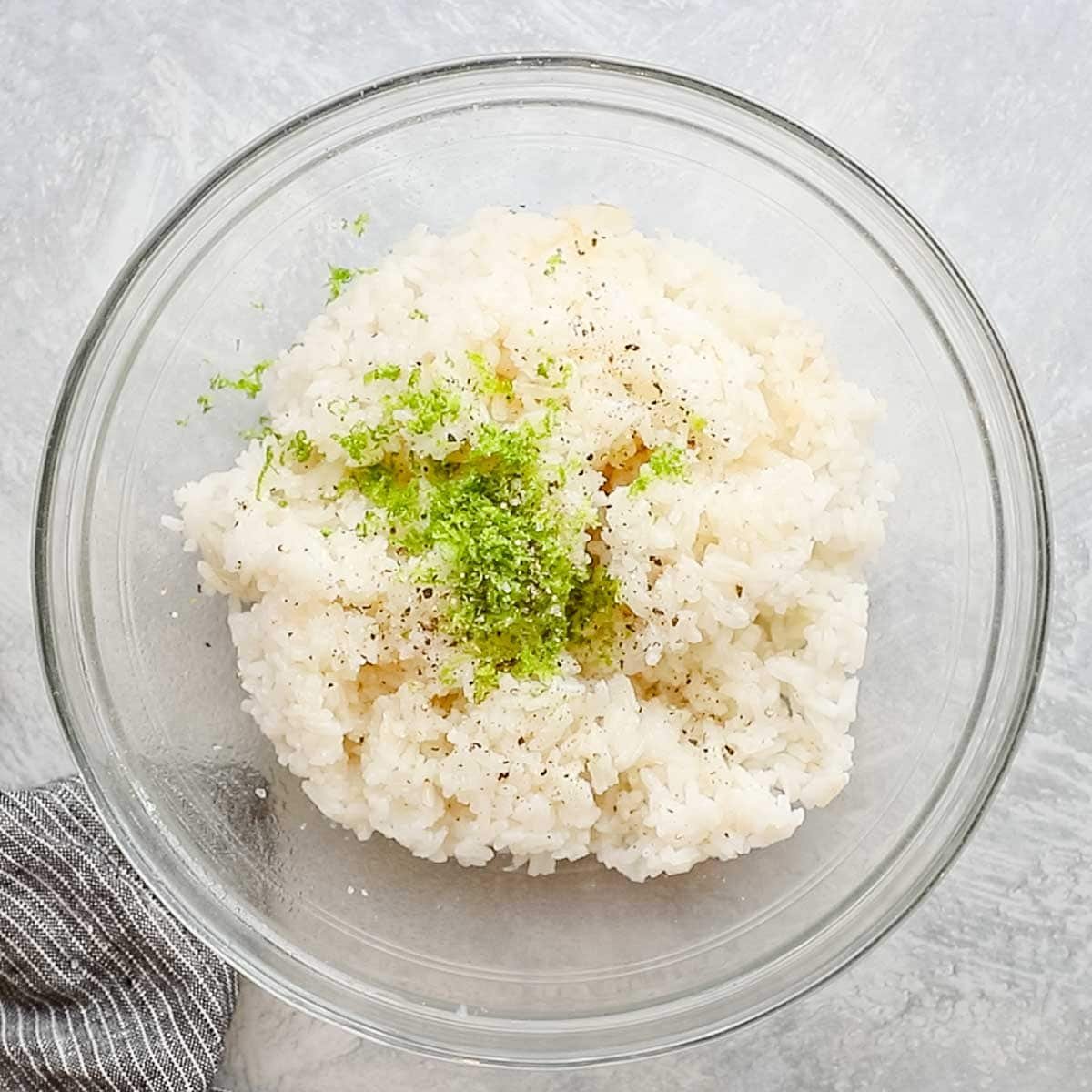 lime zest and salt added to a bowl of rice