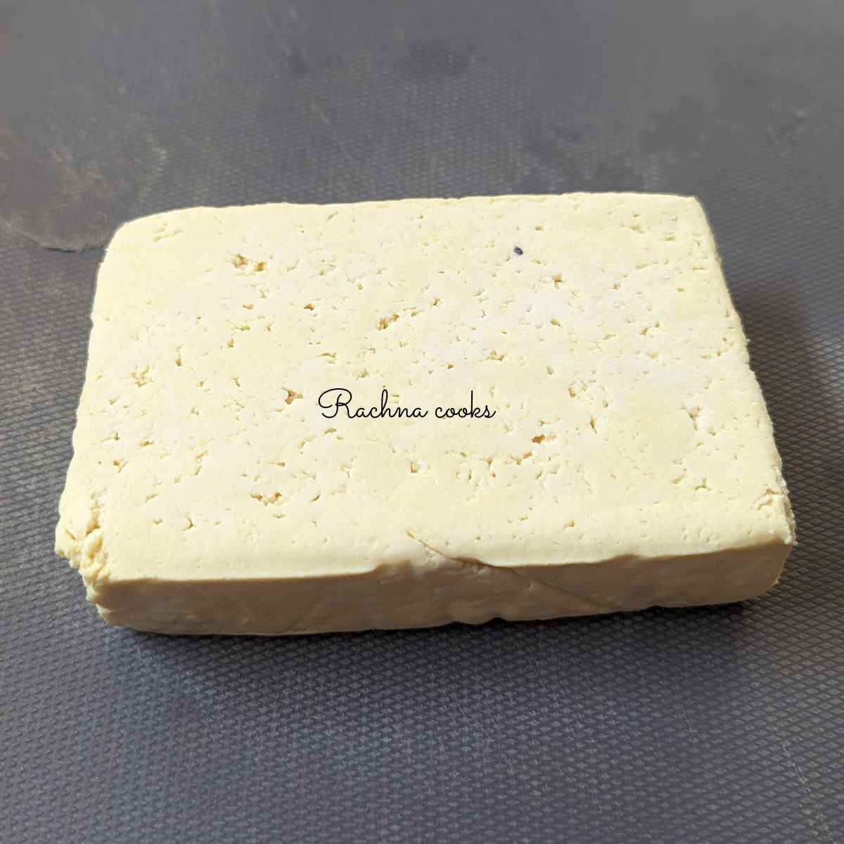 Tofu block on a chopping board