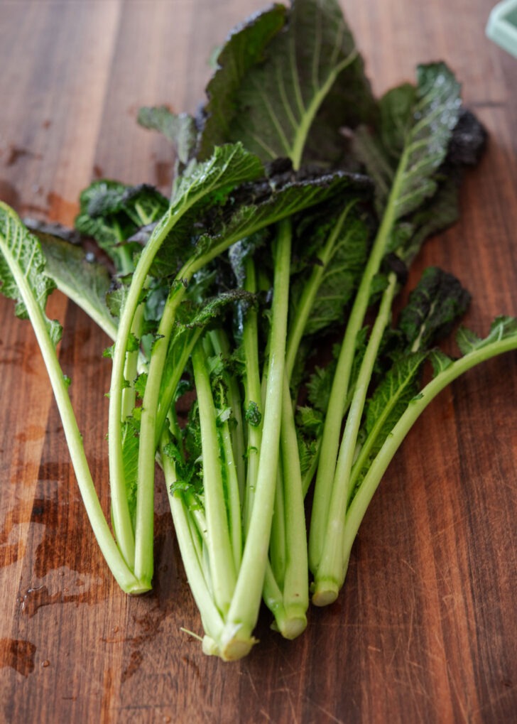Mustard green placed on a chopping board.
