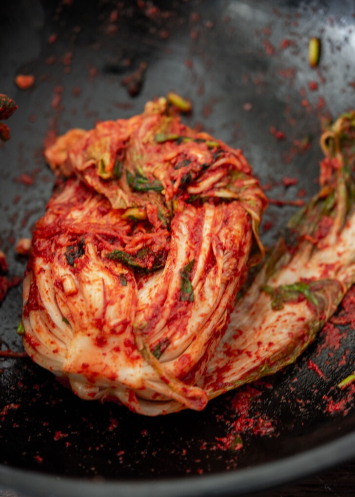Whole cabbage kimchi assembled with seasoning paste.