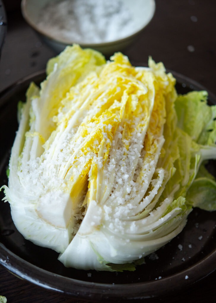 Adding more salt on the stem parts of cabbage.