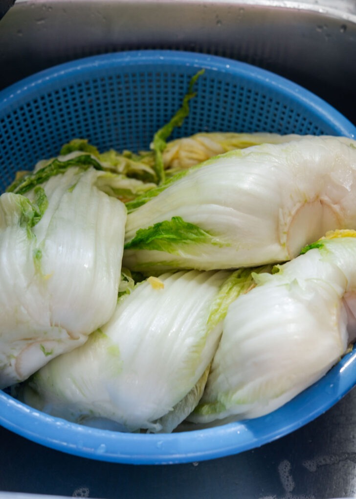 Draining the cabbage in a strainer.