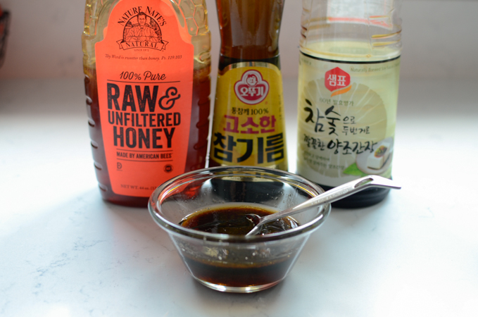 Soy sauce, honey, and sesame oil mixed in a small bowl for yujang glaze.