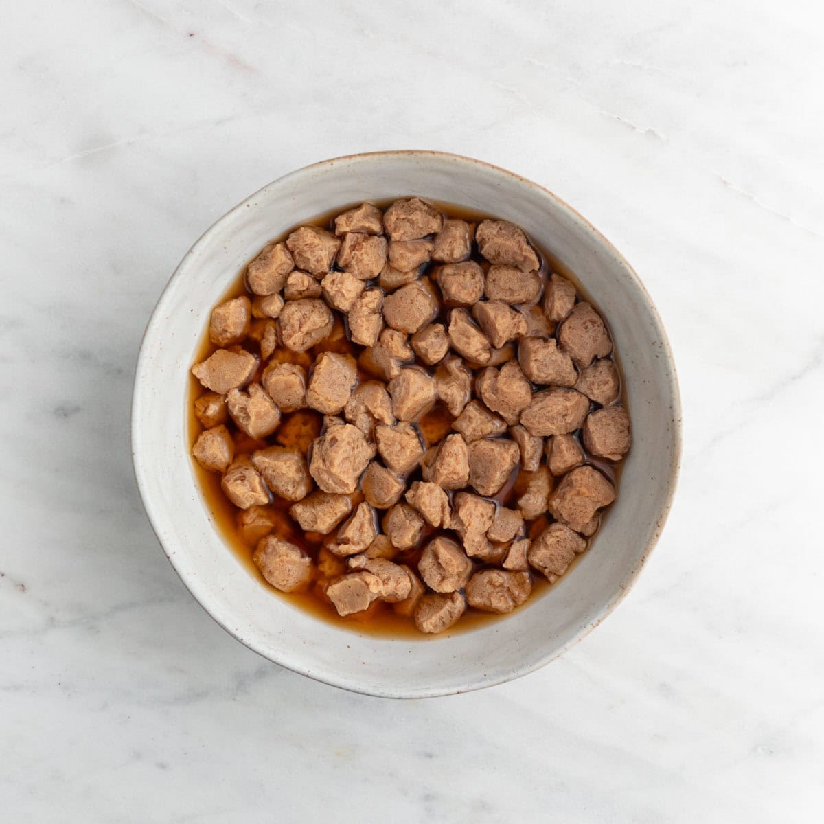 TVP chunks soaked in water and soy sauce.