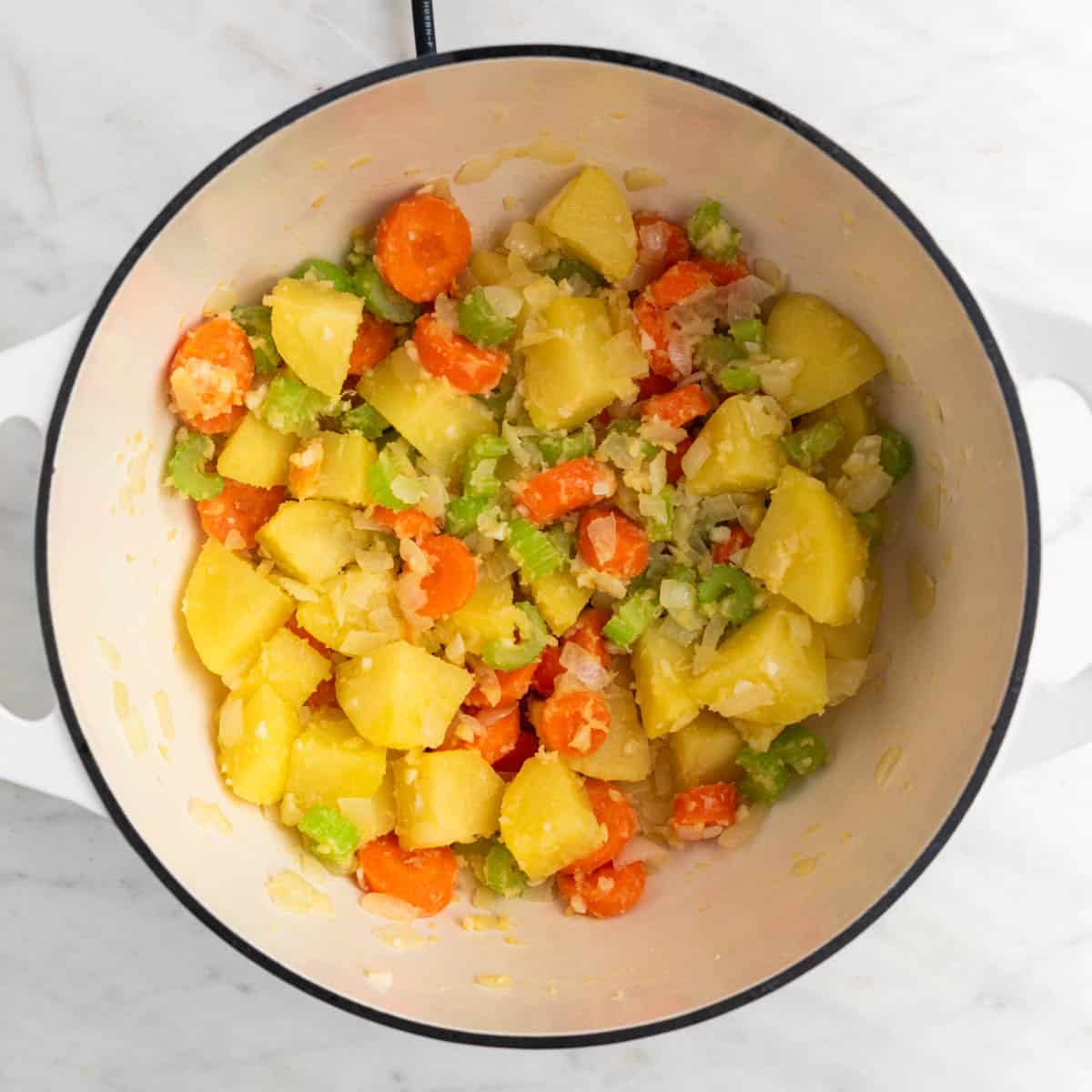 Vegetables sautéed in olive oil in a large pot with flour added and browned.