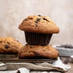 A stack of two vegan banana muffins on a muffin pan.