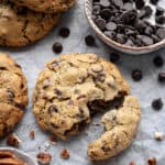 Close up of a chunky chocolate pecan cookie broken in half.