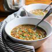 Photo showing vegetable lentil noodle soup in a bowl with a napkin.