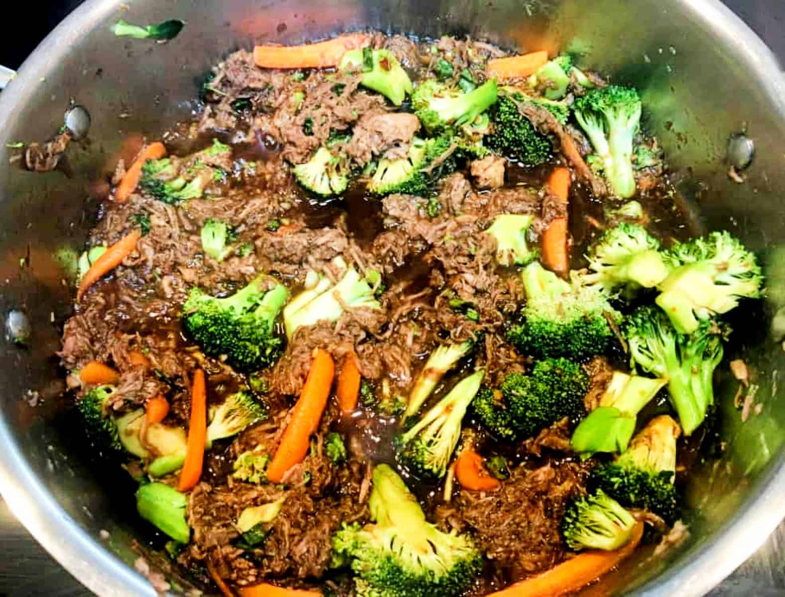 pork, noodles , and sauce cooking in a pan