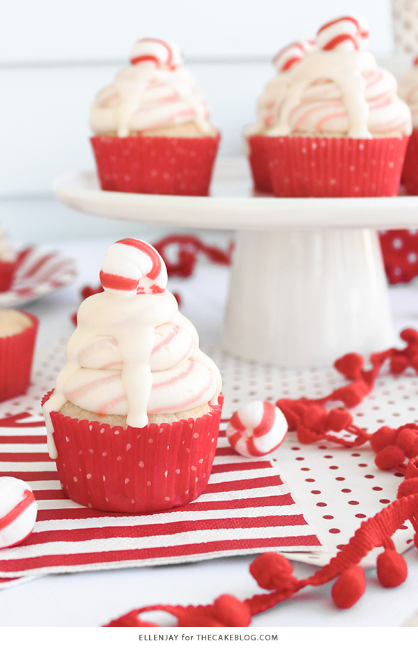 White Chocolate Peppermint Cupcakes - delicious white cake speckled with candy canes, topped with red and white swirled buttercream and white chocolate ganache | by ellenJAY for TheCakeBlog.com